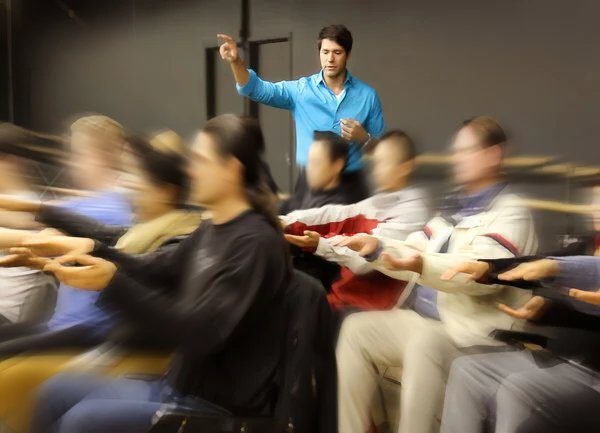 Dr. Theo Kousouli teaching a group of students hypnosis and Spiritual Healing