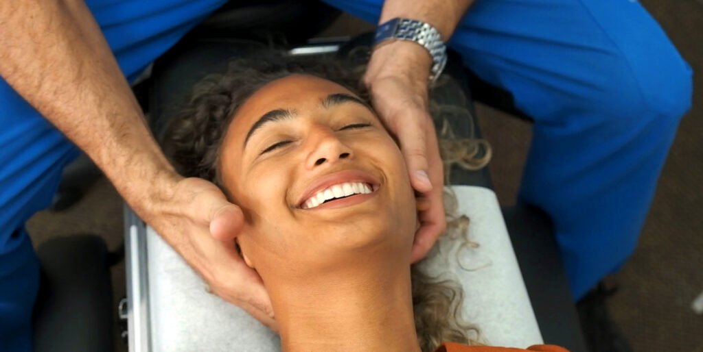 Client receiving chiropractic care for neck back pain, hypnotherapy, and holistic wellness treatment with Dr. Theo Kousouli in Mount Kisco, NY