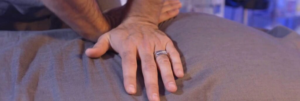 Dr. Theo Kousouli performing a mid-back chiropractic adjustment